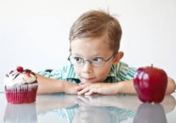 Boy choosing from an apple or a cupcake symbolic to choose between the right consultant